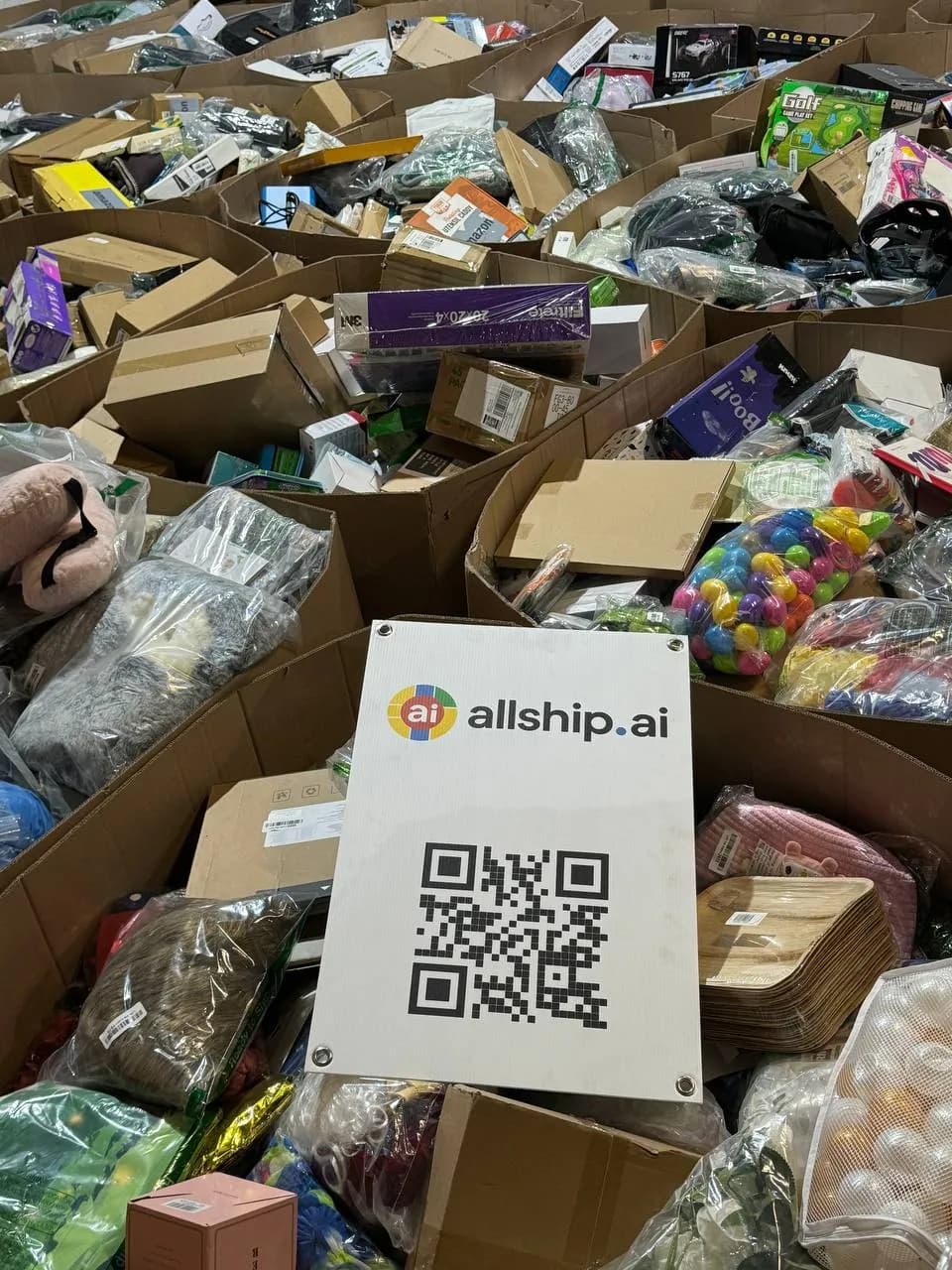 Packed household items with an AllShip AI QR card