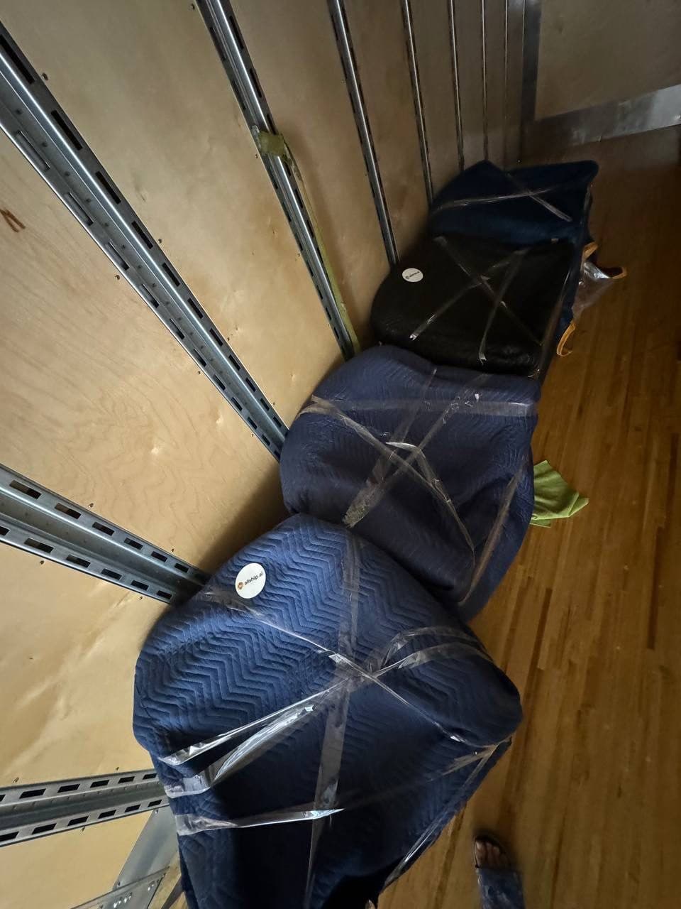 Small load of blanket-wrapped items in a truck