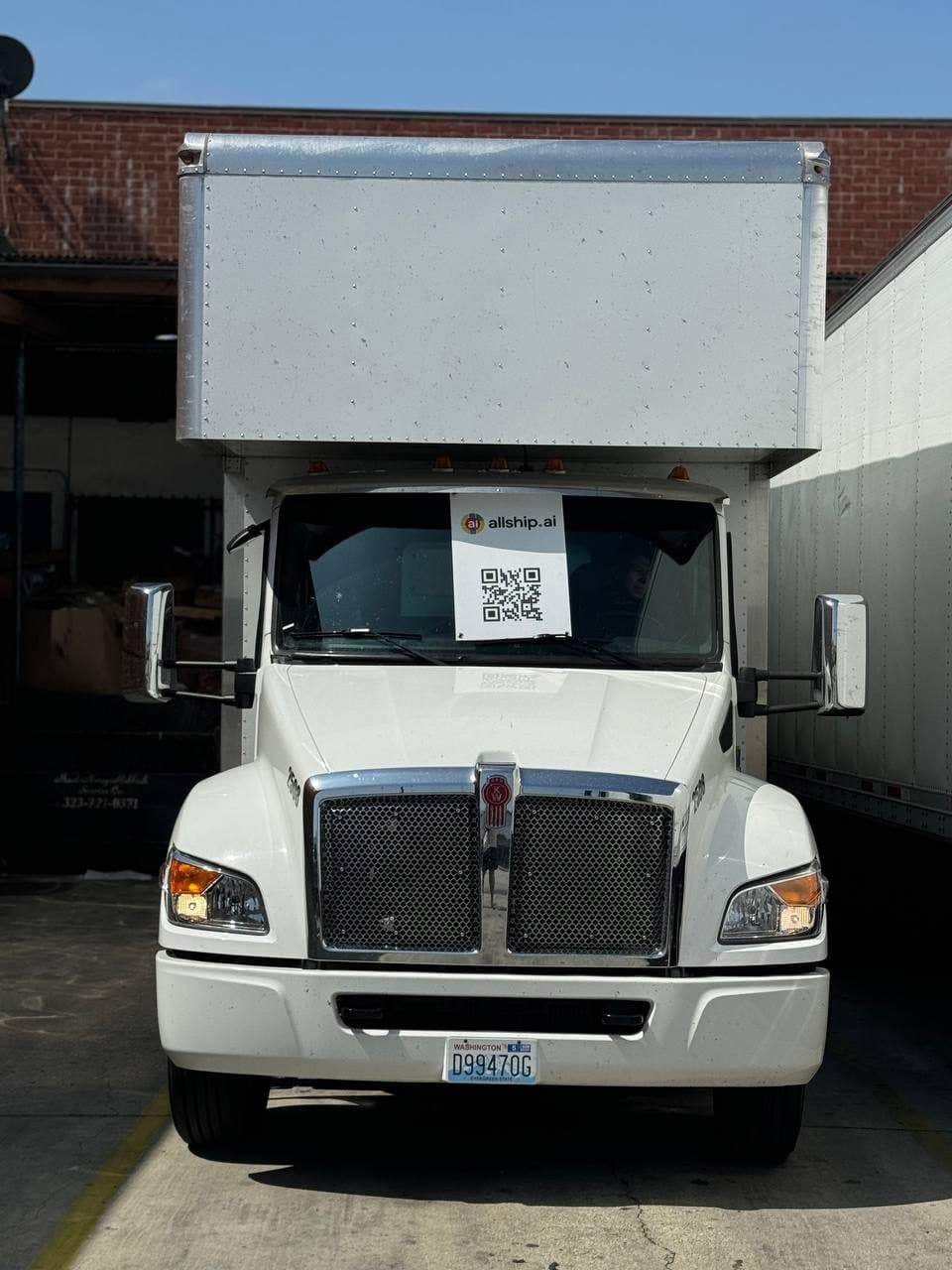 A box truck backed up to a loading dock