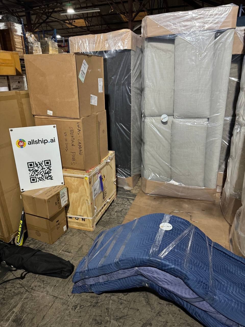 Wrapped office furniture staged for loading