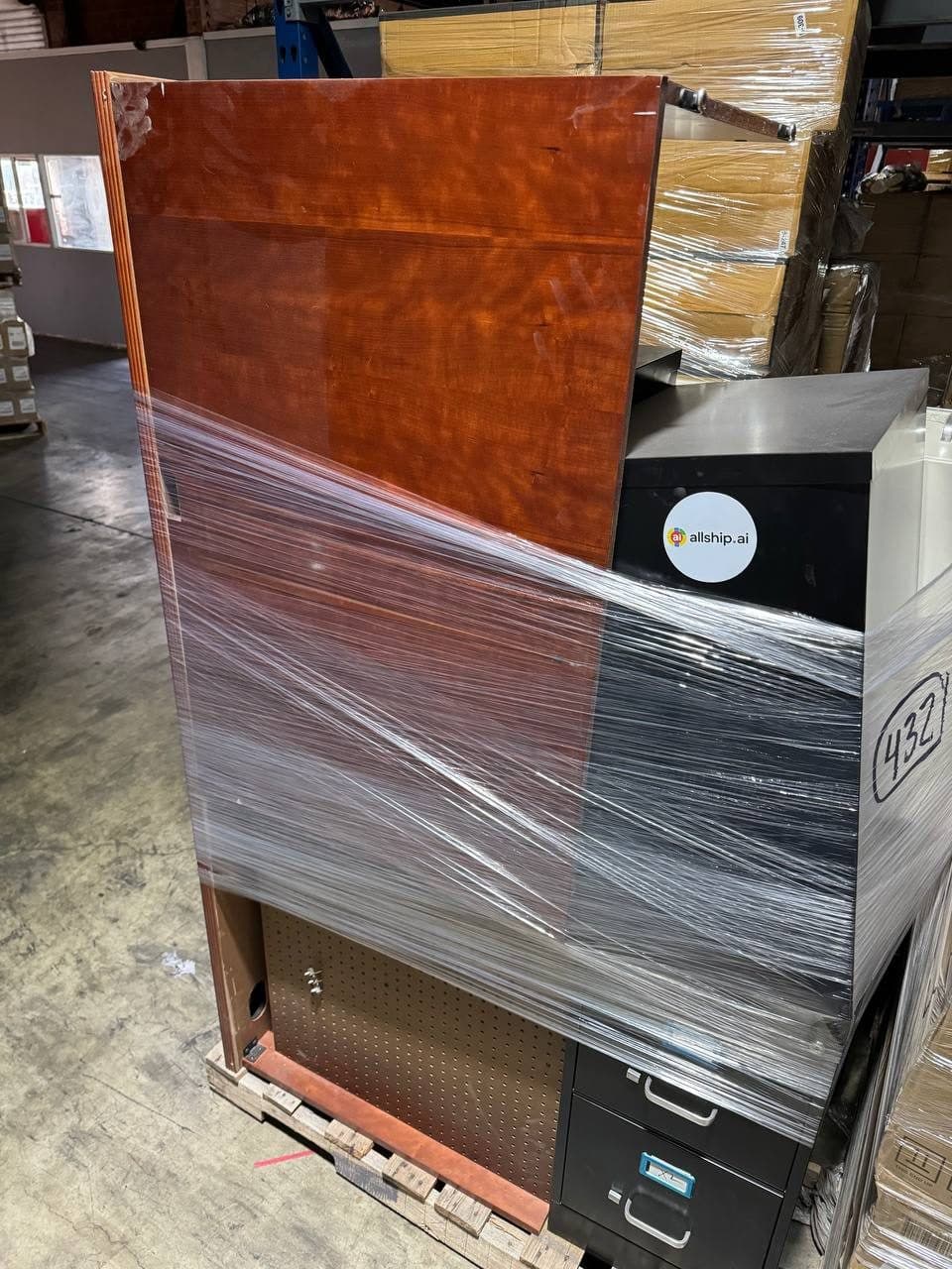 A wrapped cabinet waiting on a loading dock